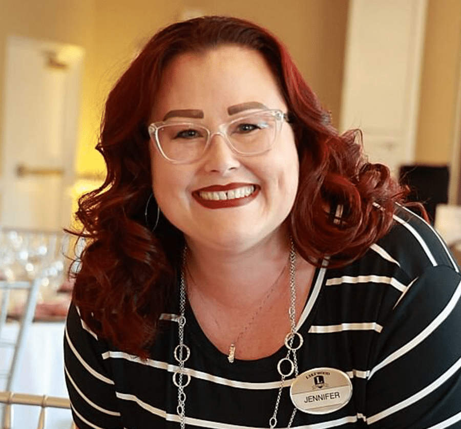 Jennifer Flores, smiling in glasses and a striped top with a Lakewood name badge