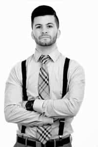 John Braca, arms crossed in a dress shirt, tie and suspenders