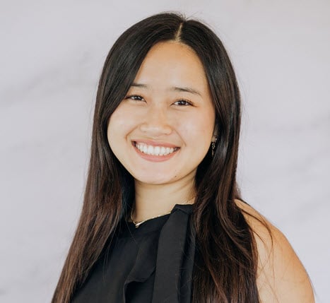 Jules Tang, smiling in a black sleeveless top