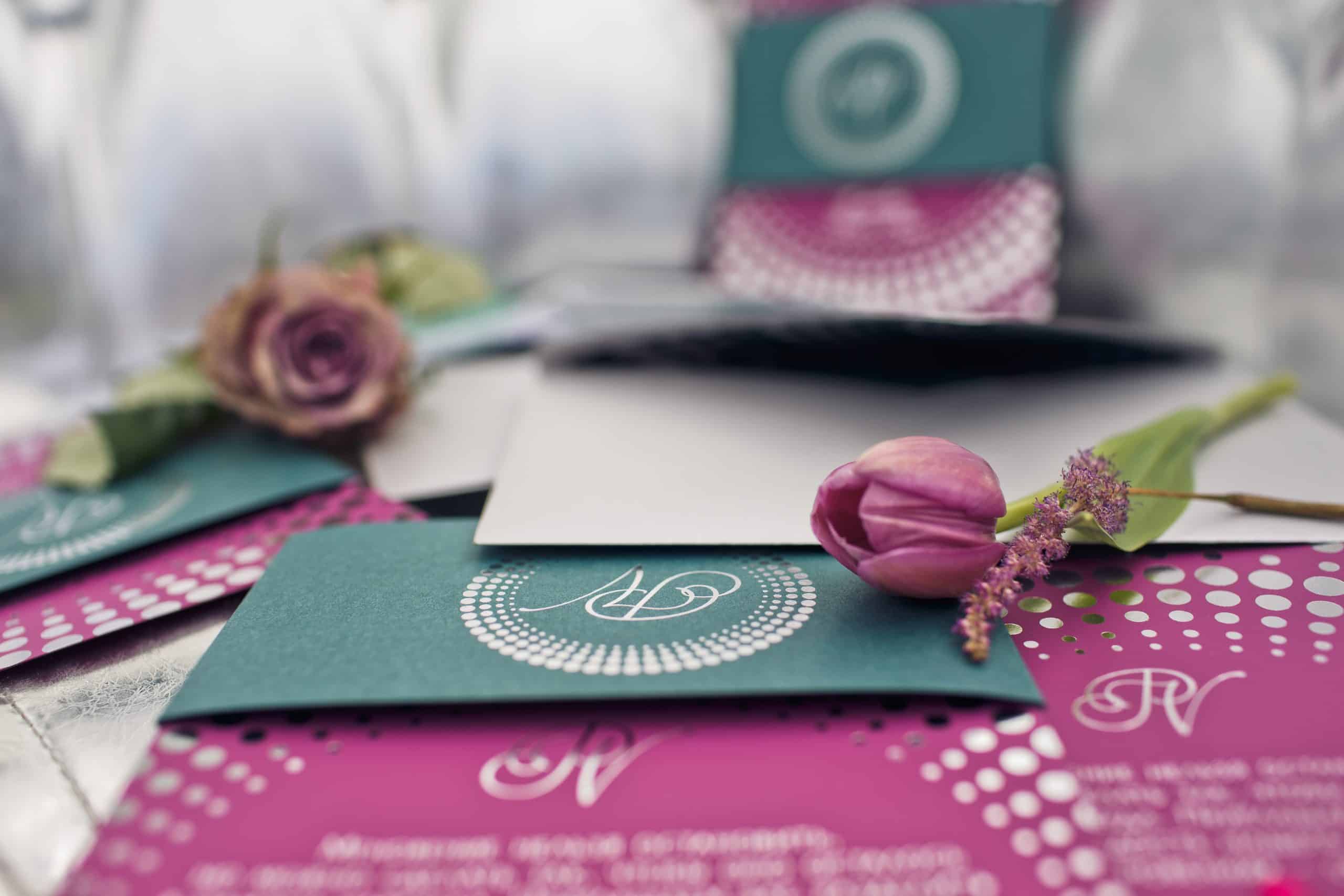Teal and magenta monogrammed wedding invitations with a tulip and rose