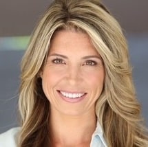 Sarah, smiling in a white collared shirt